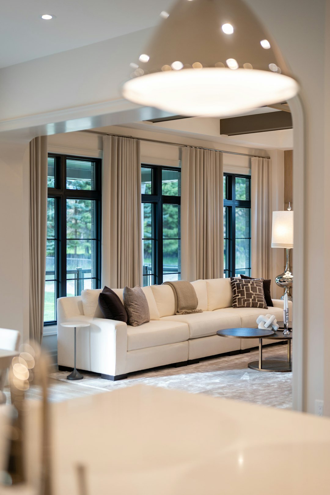 Elegant living room with warm lighting, mid-century furniture and large windows