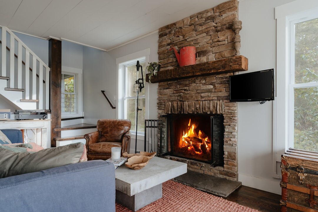 Cozy chalet living room with stone fireplace and wooden beams